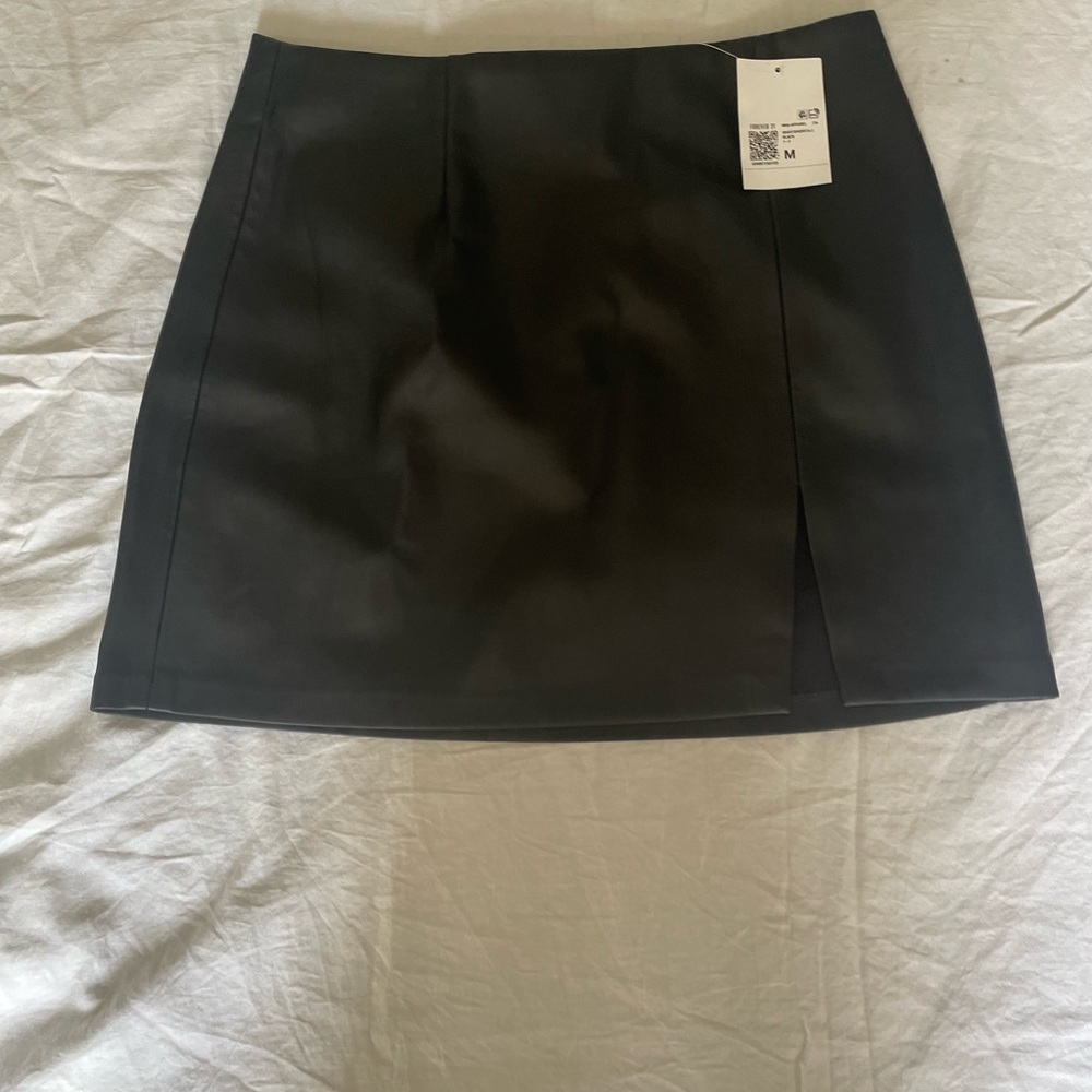 Black faux leather mini skirt.